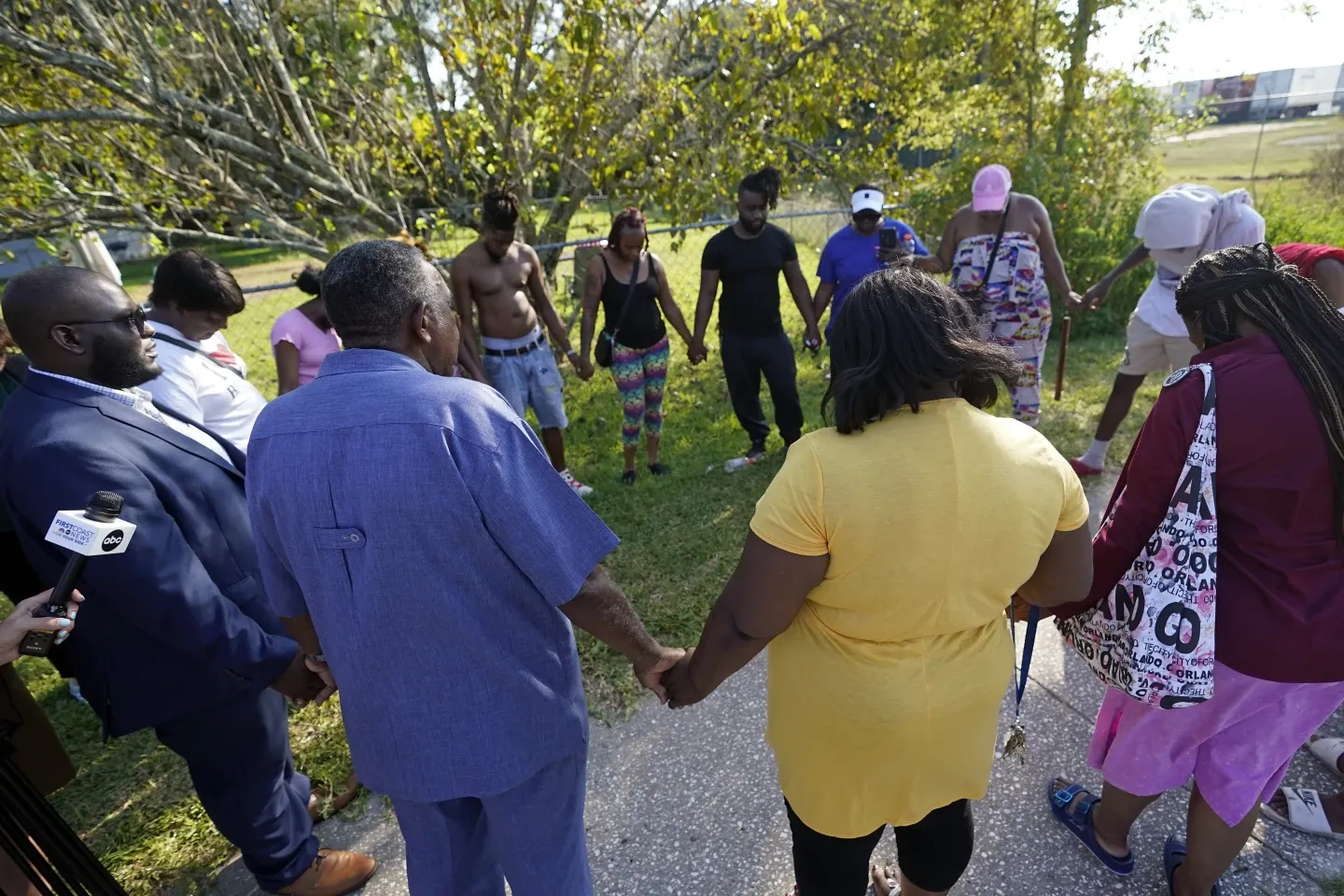 Residents gather to pray near the scene of the shooting at a Dollar General store in Jacksonville, Florida.  (AP/John Raoux).