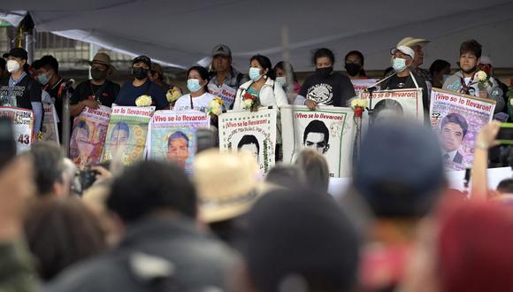 La gente participa en una marcha en la plaza Zócalo de la Ciudad de México el 26 de septiembre de 2022, para conmemorar el octavo aniversario de la desaparición de 43 estudiantes de la escuela de formación docente en Ayotzinapa.  (Foto por ALFREDO ESTRELLA / AFP)