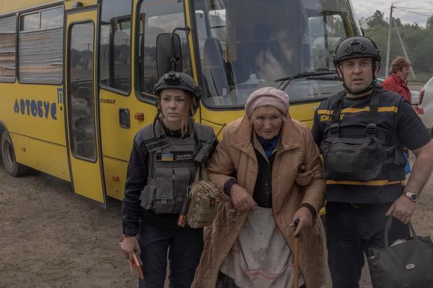 An evacuee arrives by bus at a site in the Kharkiv region amid the Russian invasion of Ukraine on May 12, 2024.  (Photo by Román PILIPEY / AFP).