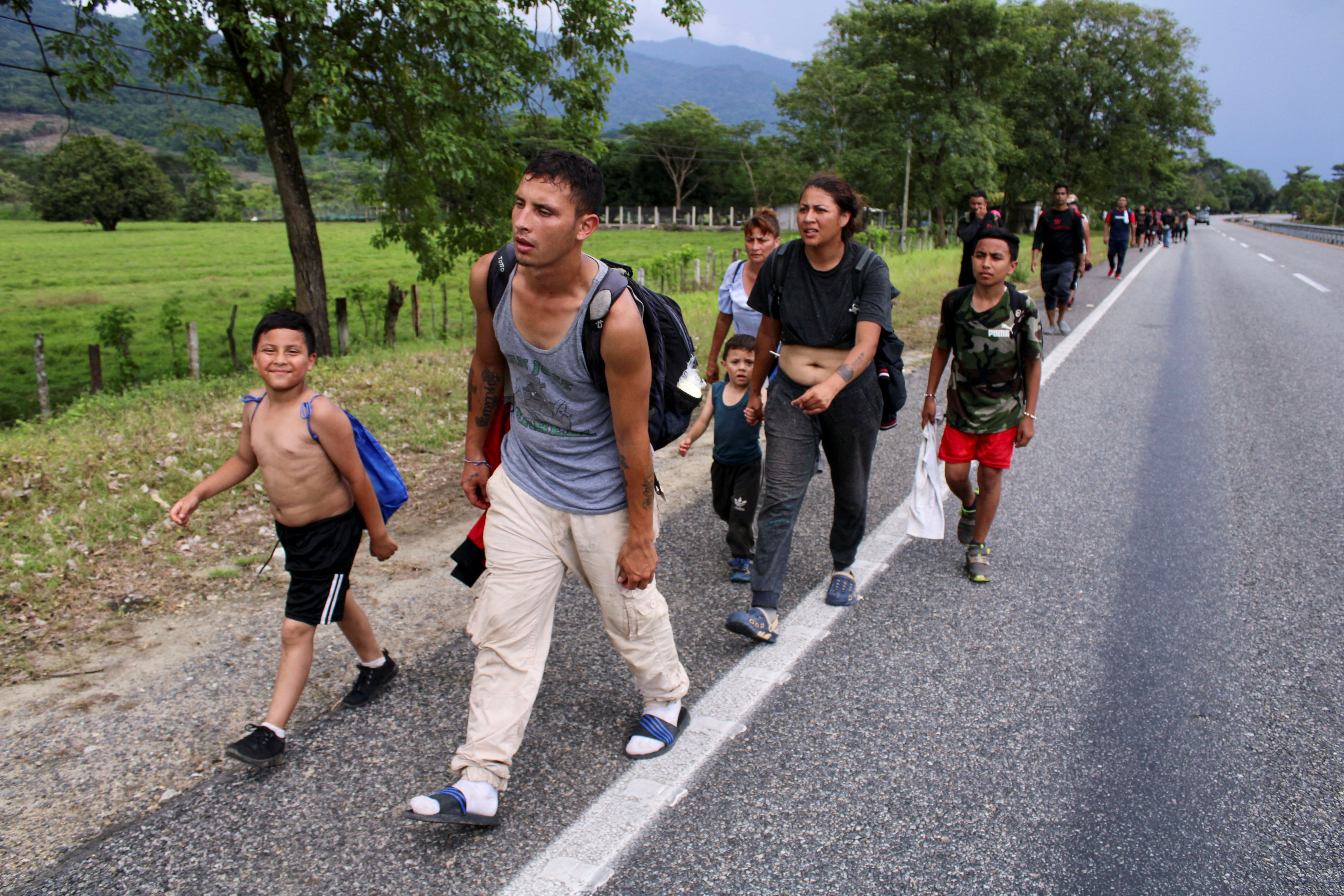 Migrants from Venezuela walk in a caravan toward the US-Mexico border, where hundreds of people are stranded following an agreement to expel Venezuelan migrants in Huixtla, Mexico.