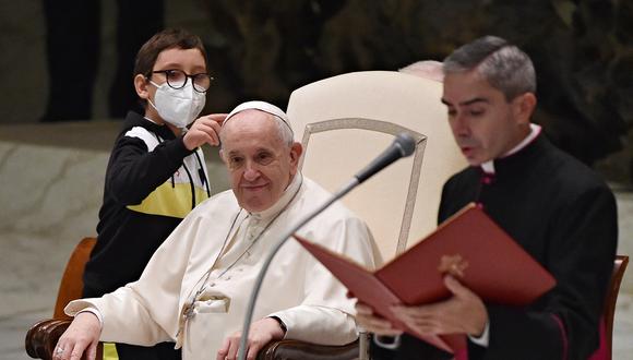 El Papa Francisco es recibido por un niño durante la audiencia general semanal en la sala Pablo VI del Vaticano el 20 de octubre de 2021. (Foto: ANDREAS SOLARO / AFP).