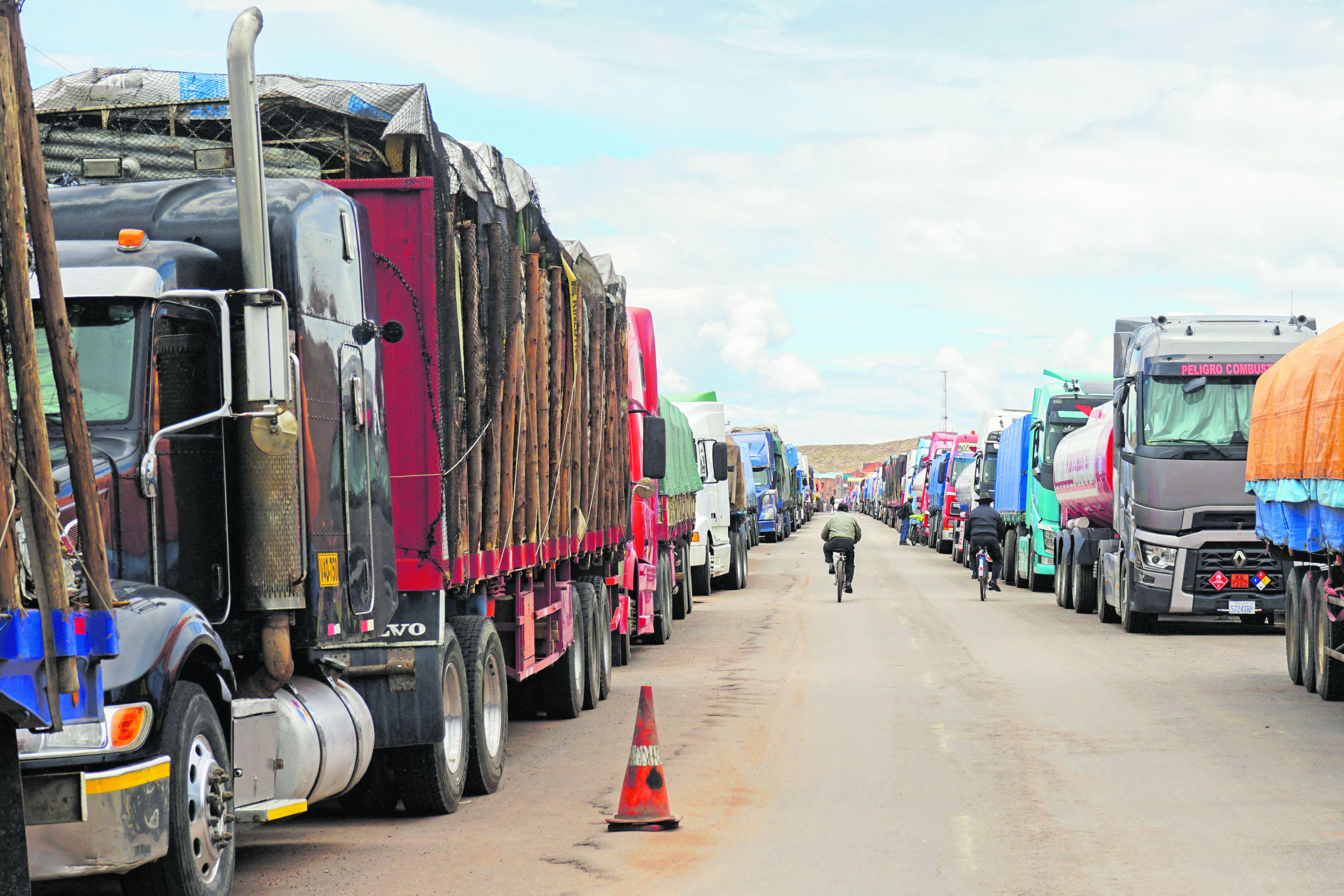 Más de 300 camioneros mantienen sus vehículos alineados durante días esperando que se abra la carretera a Bolivia en el paso fronterizo de Desaguadero, en Puno. (Foto: Bernat BIDEGAIN / AFP)