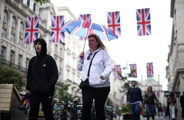 People walk in the streets of London.  (REUTERS)