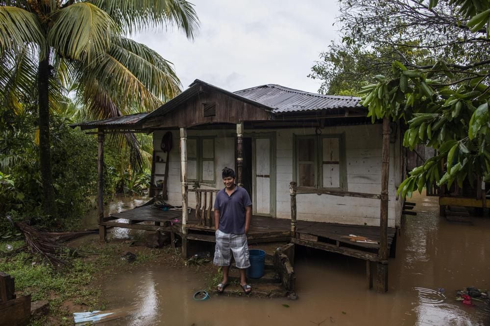A man stands outside his home amid flooding after Hurricane Julia hit the area in Bluefields, Nicaragua, Sunday, Oct. 9, 2022. (AP Photo/Inti Ocon)