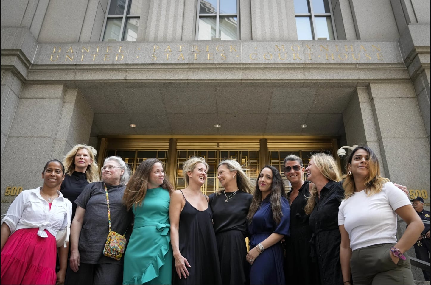 Dr. Robert Hadden's victims stand before a federal court on July 25, 2023. (AP/John Minchillo).