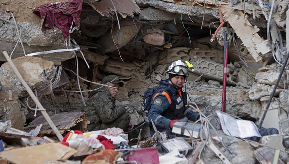 El personal de rescate ruso busca sobrevivientes y víctimas bajo los escombros de un edificio derrumbado en la ciudad de Jableh, en la provincia noroccidental de Siria de Latakia, luego de un terremoto, el 7 de febrero de 2023. (Foto: AFP)