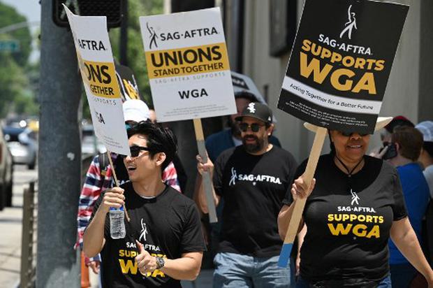 A group of Hollywood screenwriters and their supporters from the SAG AFTRA actors union demand their rights in front of the Warner Bros. studios in Burbank, California, on June 30, 2023. AFP