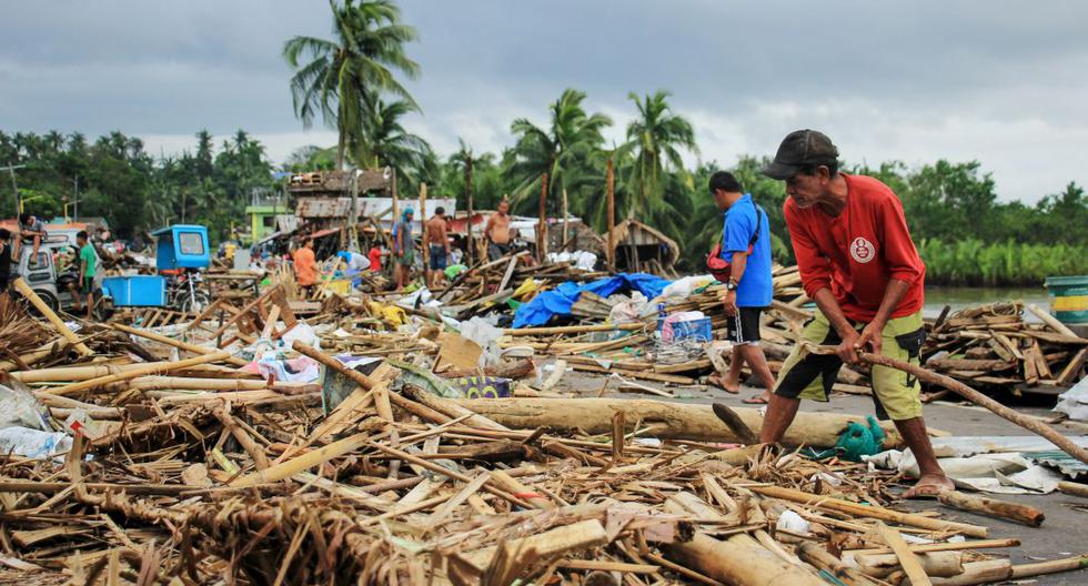 Un grupo de vecinos recogen escombros de sus casas destruidas después de que el tifón Kammuri golpeara la ciudad de Sorsogon, al sur de Manila. (AFP)