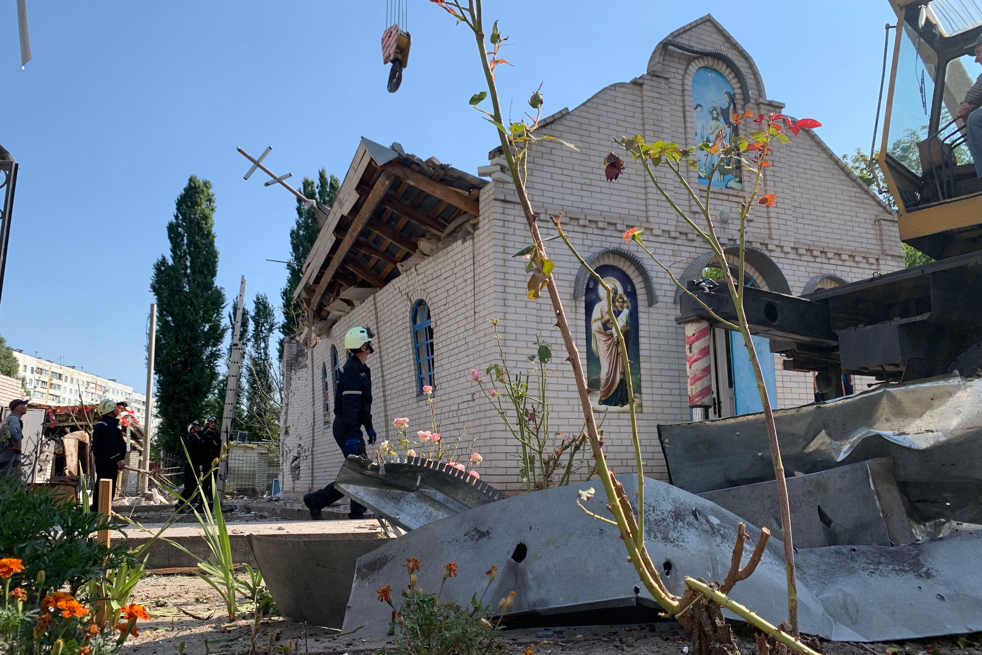 Rescuers work outside a church destroyed after a Russian missile attack in Zaporizhzhia, August 10, 2023. (Photo by Marina Moiseyenko / AFP).