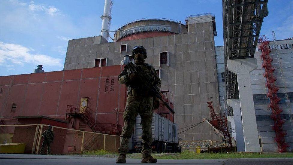 A Russian soldier guards the entrance to the Zaporizhia plant.