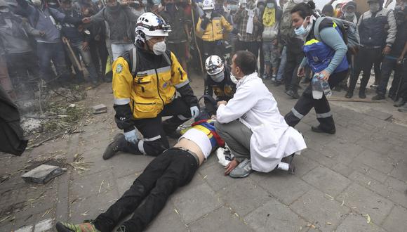 Los paramédicos atienden a un manifestante antigubernamental herido durante los enfrentamientos con la policía en Quito, Ecuador. (Foto AP / Fernando Vergara).