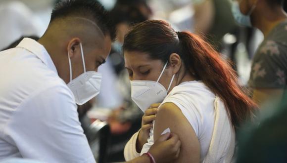 Un vacunador tras aplicar una dosis de la vacuna contra la covid-19 a una mujer, en Ciudad de México. (Foto: EFE/ Sáshenka Gutiérrez ARCHIVO).