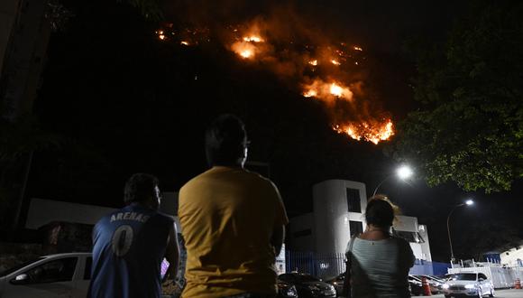 La gente ve un incendio en el Morro dos Cabritos en el barrio de Copacabana, Río de Janeiro, Brasil.
