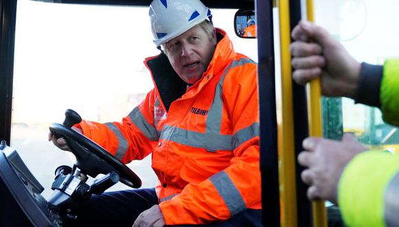 El primer ministro británico, Boris Johnson, conduce una máquina mientras visita los muelles de Tilbury el 31 de enero de 2022. (Matt Dunham / AFP).