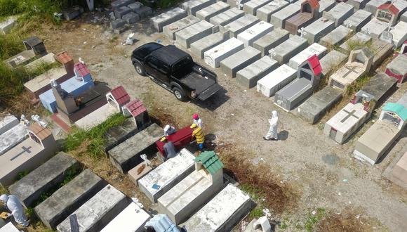 Trabajadores entierran un ataúd en el cementerio de María Canals en las afueras de Guayaquil, Ecuador, uno de los países de Sudamérica más golpeados por el coronavirus. (AFP / Jose Sánchez).