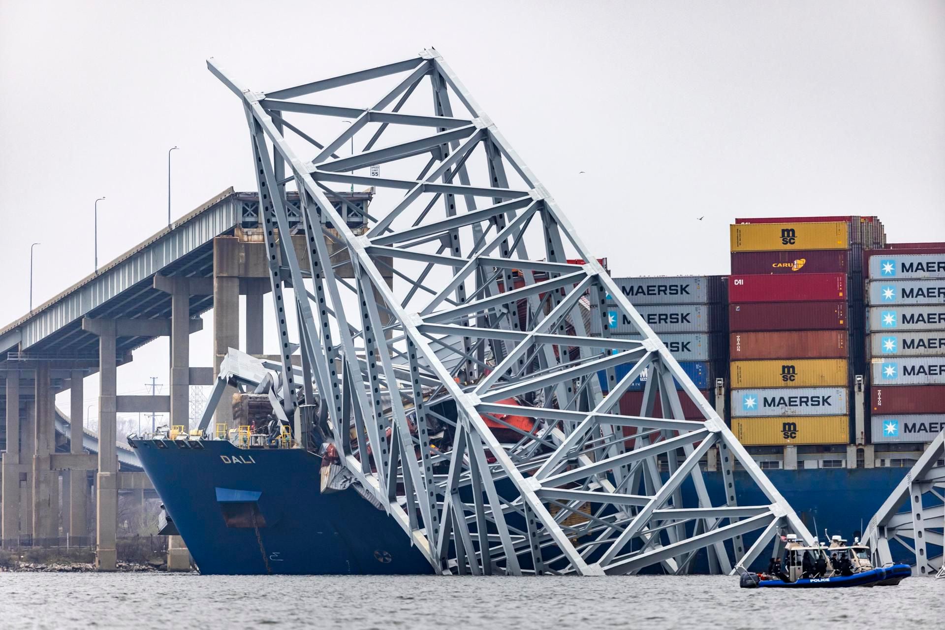 The remains of the Francis Scott Key Bridge remain atop the freighter Dali.  (EFE/EPA/JIM LO SCALZO).