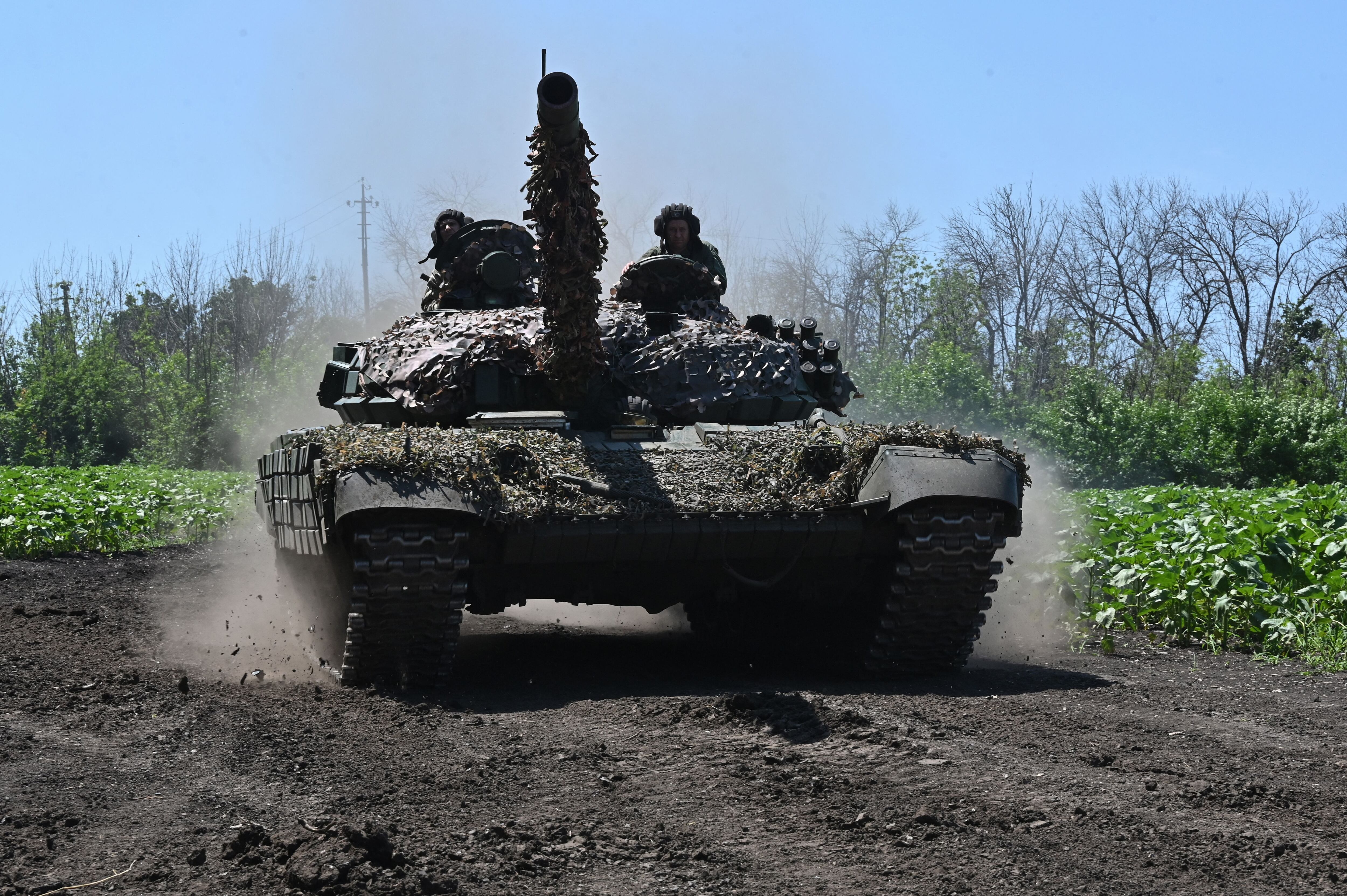 Ukrainian servicemen ride in a tank near the front line in the Kharkiv region, on July 6, 2023, amid the Russian invasion of Ukraine.  (Photo by SERGEY BOBOK / AFP).