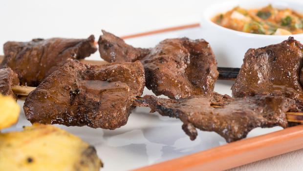 The anticuchos are made from cow heart cut into squares, and accompanied with boiled potatoes, chili and corn.