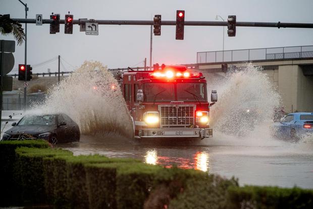 A Riverside County fire truck wades through flood waters during Tropical Storm Hillary in Coachella, California.