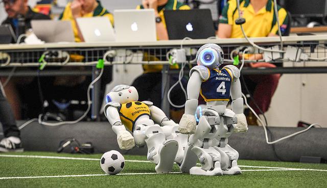 Two robots battle it out for the soccer ball in Sydney on July 21, 2017, as Australiaís five-time world champions of robot soccer, the University of New South Wales' (UNSW) Runswift team, heads to Japan this weekend to try and recapture the international trophy for a record sixth time, facing off against powerful teams from Germany and the USA. There are 24 teams from 15 nations competing in the 2017 RoboCup World Championships to held at the Nagoya International Exhibition Hall in Japan from 27 to 30 July.  / AFP / WILLIAM WEST