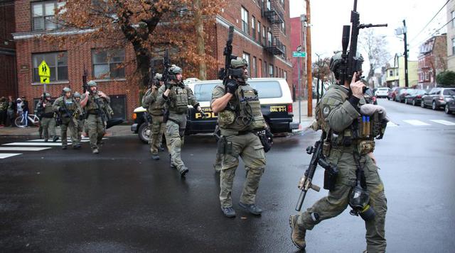 Los agentes de policía llegan al lugar donde se produjo un tiroteo en un supermercado de Jersey City que deja al menos seis muertos. (Foto: AFP).