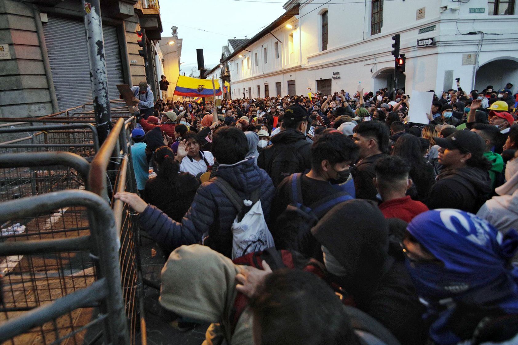 Demonstrators shout slogans next to a fence during clashes with the police as part of the protests led by indigenous people against the government of President Guillermo Lasso that began on Monday, in the surroundings of the Carondelet government palace, in Quito.