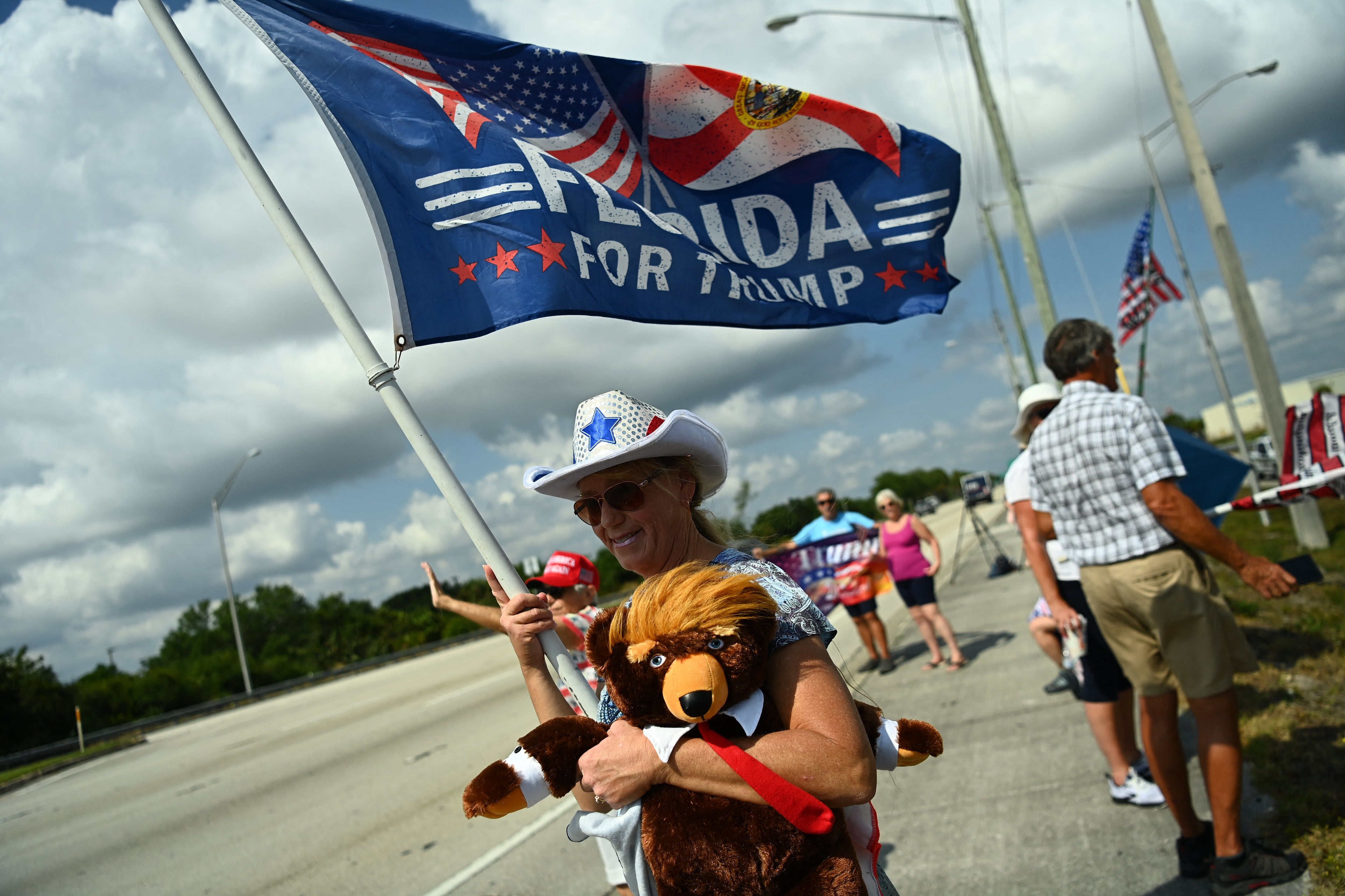 Trump supporters gather at Palm Beach International Airport, on April 3, 2023, before his departure for New York.  (Photo by CHANDAN KHANNA / AFP).