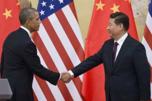 Barack Obama and Xi Jinping shake hands in a historic climate agreement.