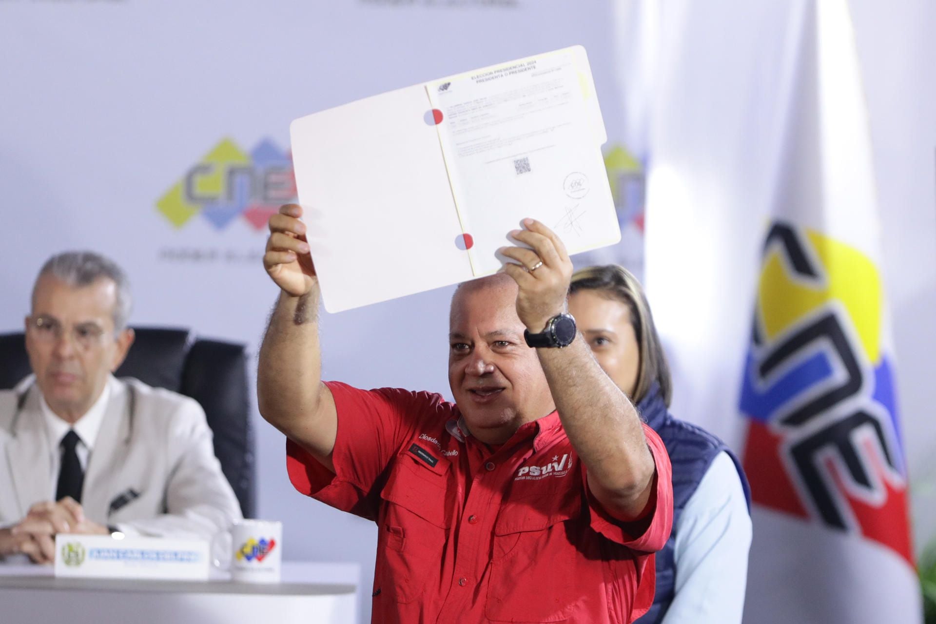 The first vice-president of the United Socialist Party of Venezuela (PSUV), Diosdado Cabello, shows the document with which he registered the president of Venezuela, Nicolás Maduro, as a candidate for the presidential elections on July 28.  (EFE/ Rayner Peña R.).