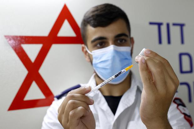 An Israeli medical worker developed the dosage of the COVID-19 vaccine during a campaign by Tel Aviv City Council to encourage teens to be vaccinated.  (Photo: AFP)