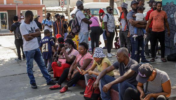 Decenas de migrantes de origen haitiano permanecen afuera del albergue Movimiento Juventud 2000, a la espera de un lugar de hospedaje, el 26 de septiembre de 2022 en la fronteriza Tijuana, Baja California (México). La llegada de migrantes que buscan asilo en el límite de México con Estados Unidos, en la fronteriza Tijuana, se ha incrementado en casi 300 %, con albergues saturados y cientos de personas que duermen en las calles. (Foto: EFE/Joebeth Terriquez)