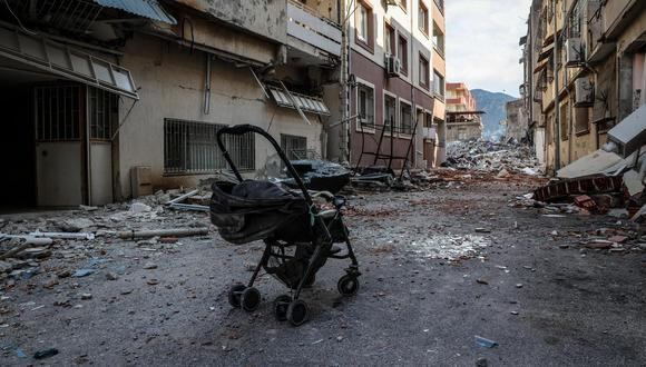 Un cochecito de bebé abandonado frente a edificios derrumbados en Antakya capital de la provincia de Hatay, la provincia más meridional de Turquía tras el potente terremoto, el 11 de febrero de 2023. (Foto: EFE/EPA/JOAO RELVAS)