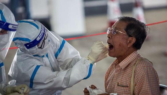 Un taxista se somete a una prueba para detectar el coronavirus COVID-19 en una estación de tests en Hong Kong, China. (Foto: ISAAC LAWRENCE / AFP).