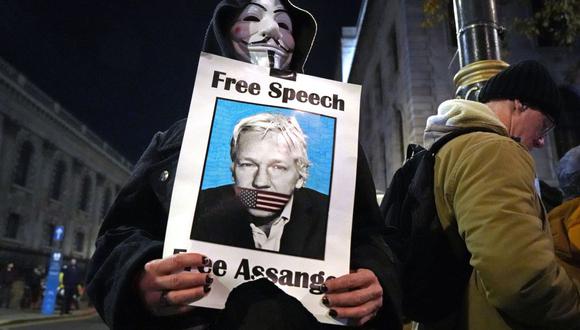 Un manifestante sostiene una foto del fundador de WikiLeaks, Julian Assange, en una reunión en Trafalgar Square el 5 de noviembre de 2020. (Foto de Niklas HALLE'N / AFP).
