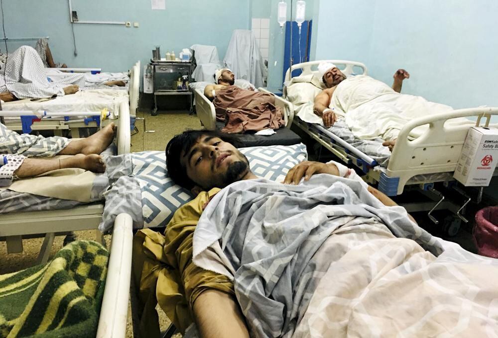 Injured Afghans lie in a hospital bed after a deadly explosion outside Kabul airport, Afghanistan, Thursday, Aug. 26, 2021. (AP Photo/Mohammad Asif Khan)