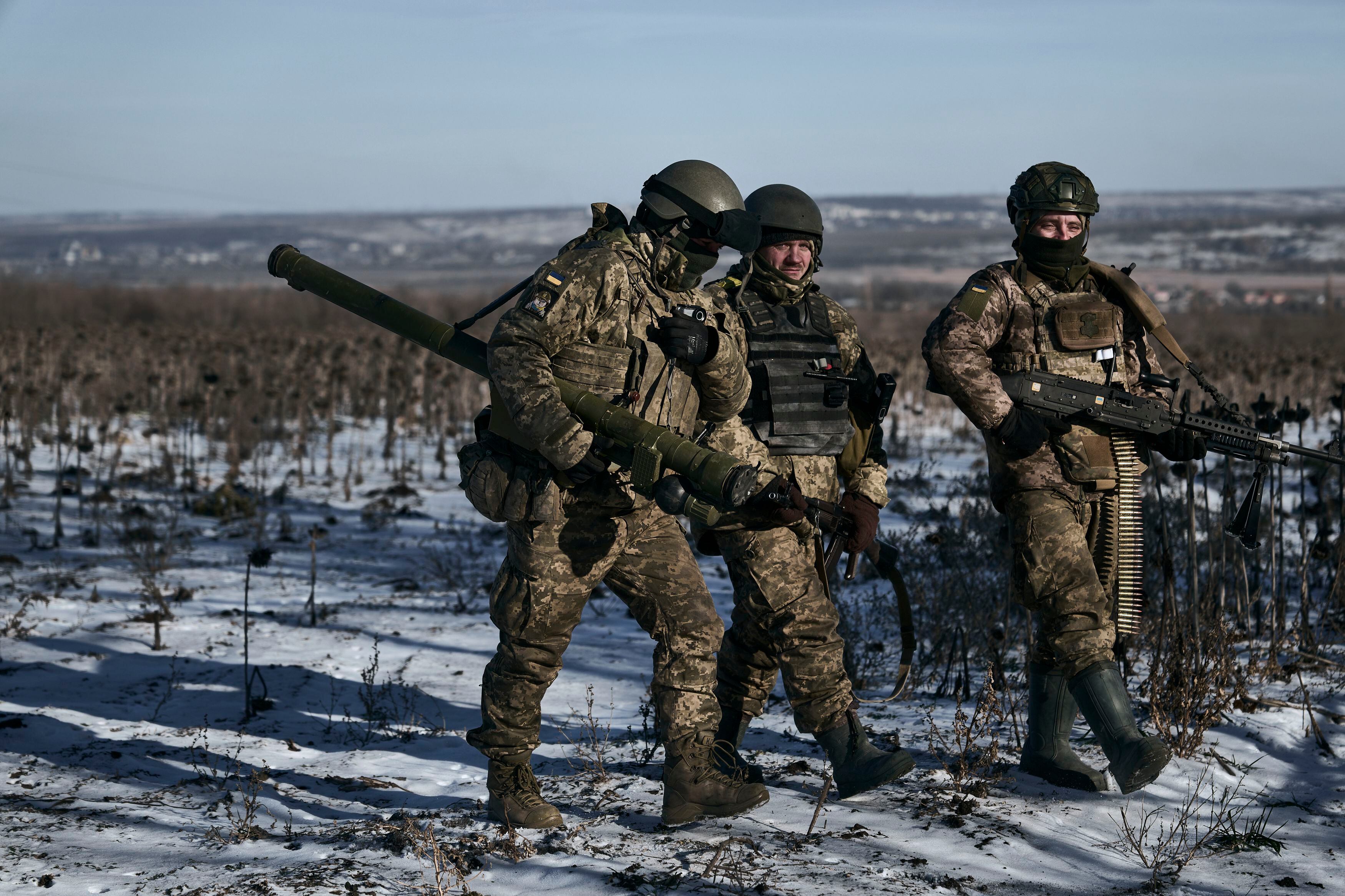 Ukrainian soldiers walk on the front line near Soledar, in the Donetsk region.  (AP Photo/Libkos)