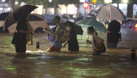 Ciudadanos se desplazan por las calles de Seúl pese a las intensas lluvias reportadas en la ciudad. (Foto: EFE/EPA/YONHAP)
