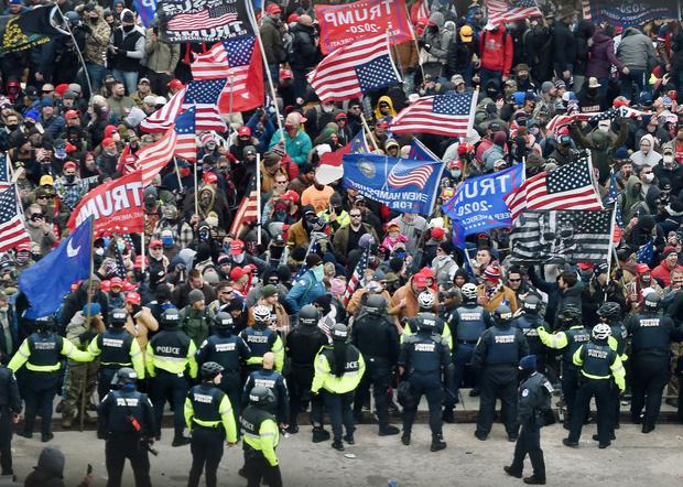 In this file photo taken on January 6, 2021, Trump supporters clash with police while storming the United States Capitol.  (OLIVIER DOULIERY / AFP).