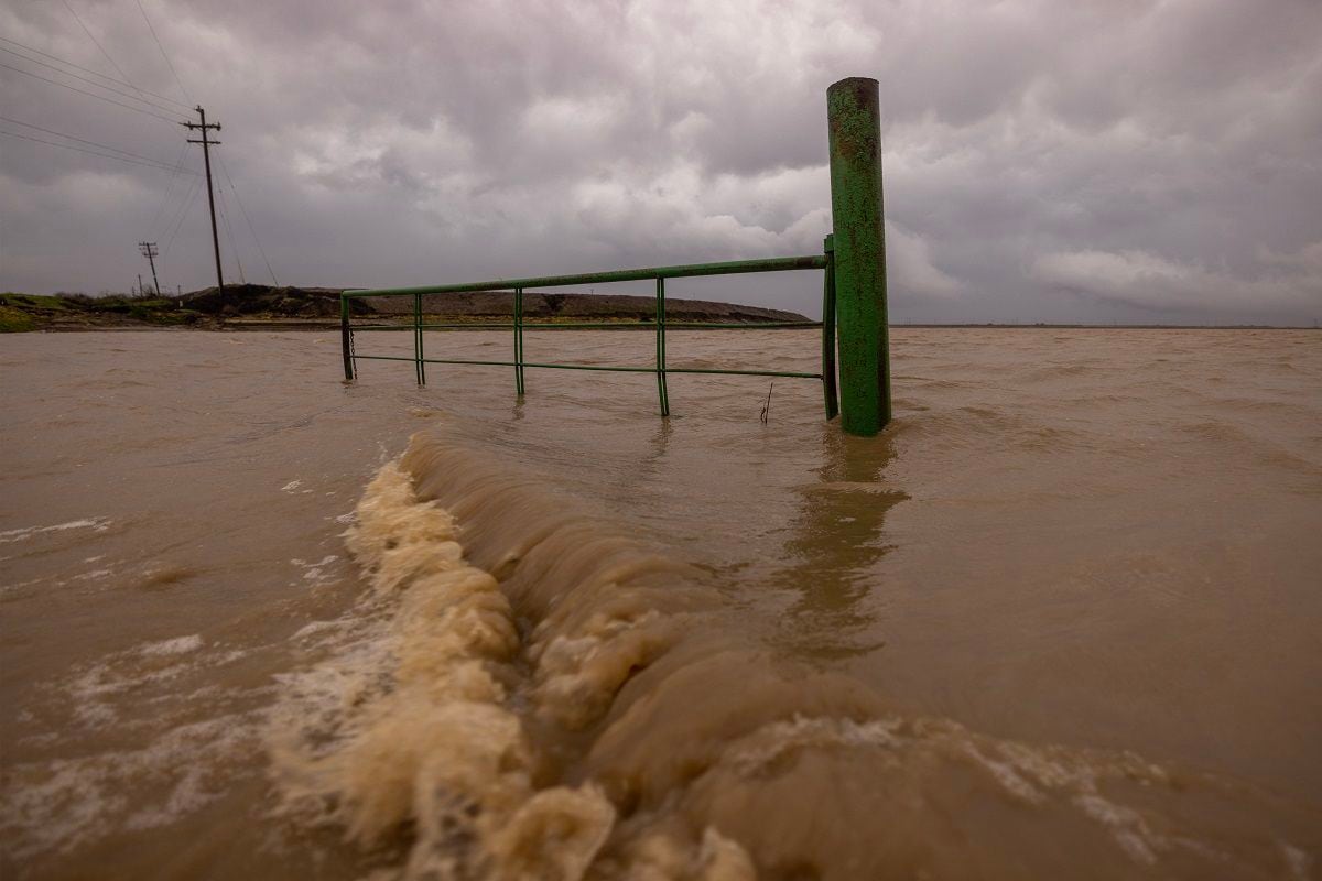 Water from the Salinas River covers a field near Chualar, California on January 14, 2023, as a series of atmospheric storms from the river continue to cause widespread destruction across the state.  (Photo by DAVID MCNEW/AFP)
