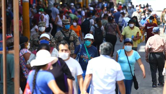 Ciudadanos recorren uno de los mercados de la capital portando mascarillas y vigilados por personal militar.