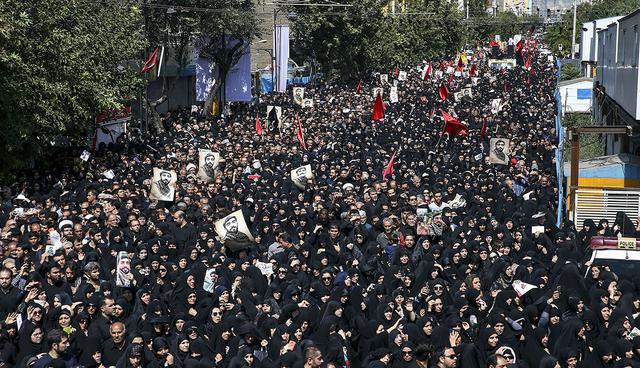 Thousands of Iranians attend the state funeral of Mohsen Hojaji, a young Revolutionary Guard soldier beheaded by the Islamic State group in Syria, in Tehran, Iran, Wednesday, Sept. 27, 2017. The death of 25-year-old Mohsen Hojaji has struck a nerve in Iran, which has suffered casualties while its troops are deployed into Iraq fighting the Islamic State group and in Syria. (AP Photo/Ebrahim Noroozi)