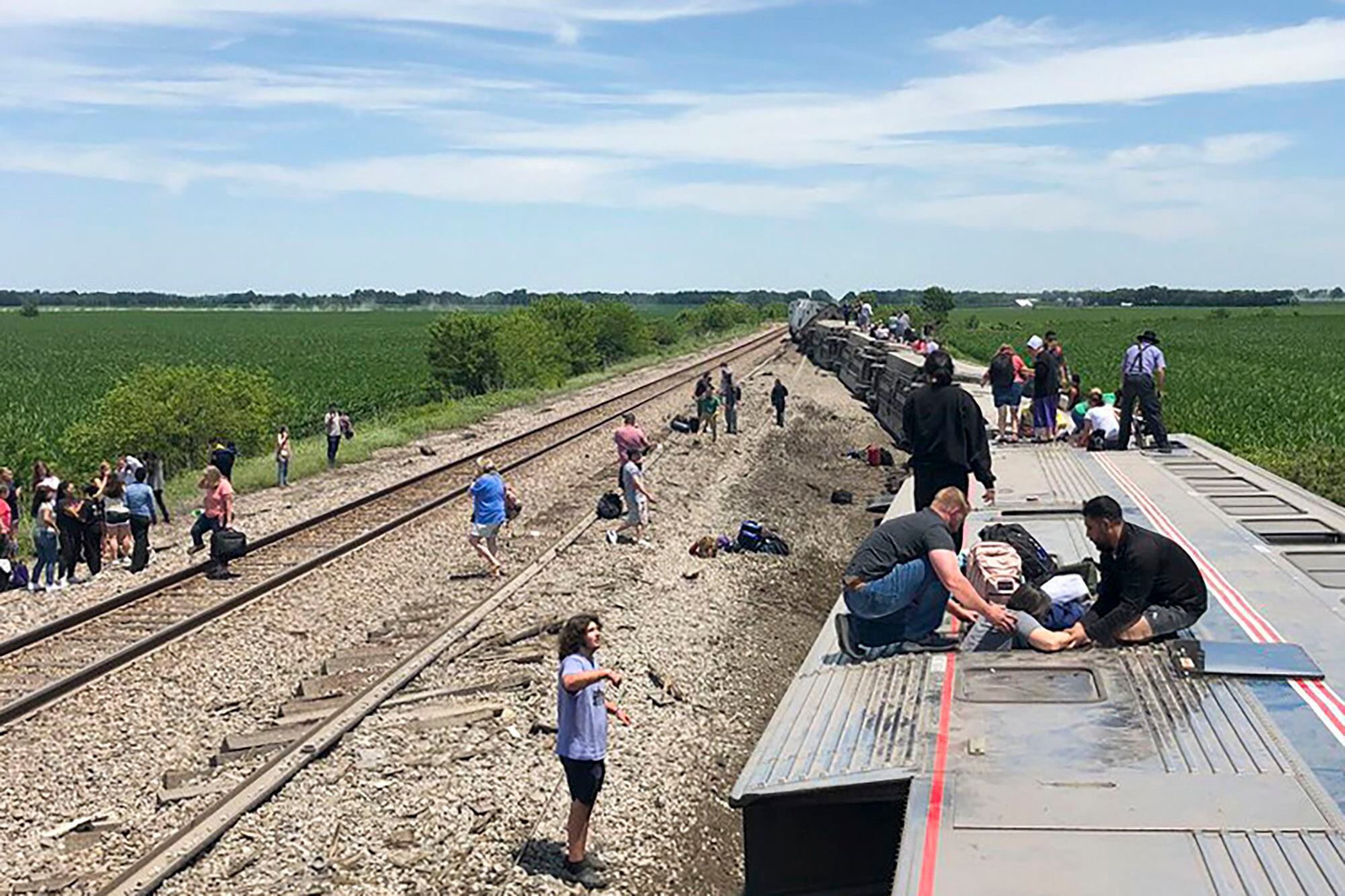 An Amtrak passenger train lies on its side after derailing near Mendon, Missouri.