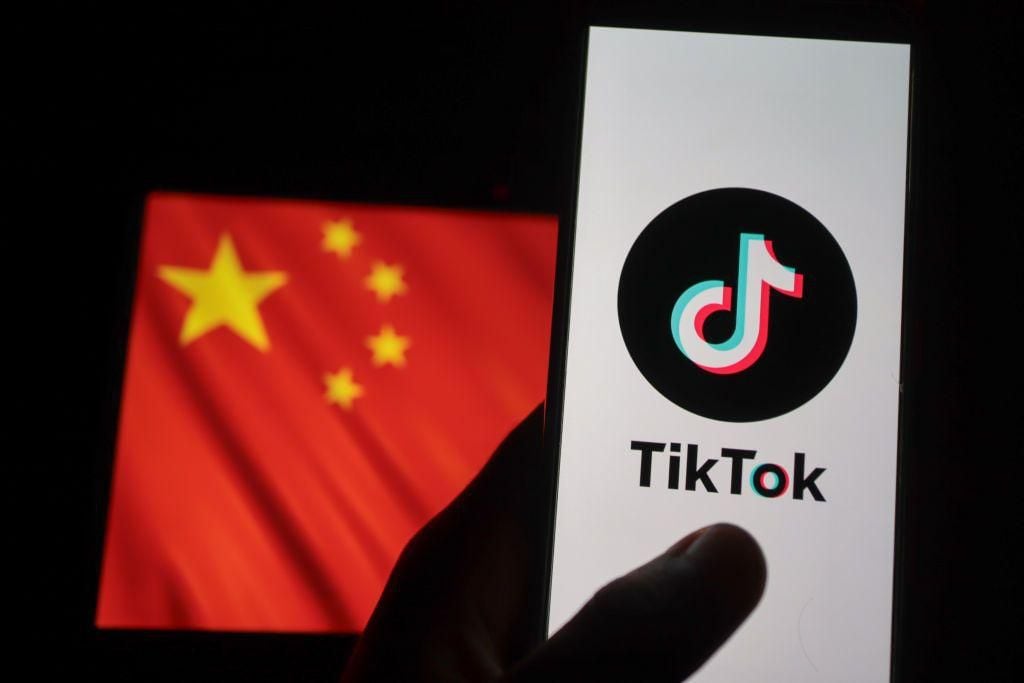 The TikTok logo with the Chinese flag behind