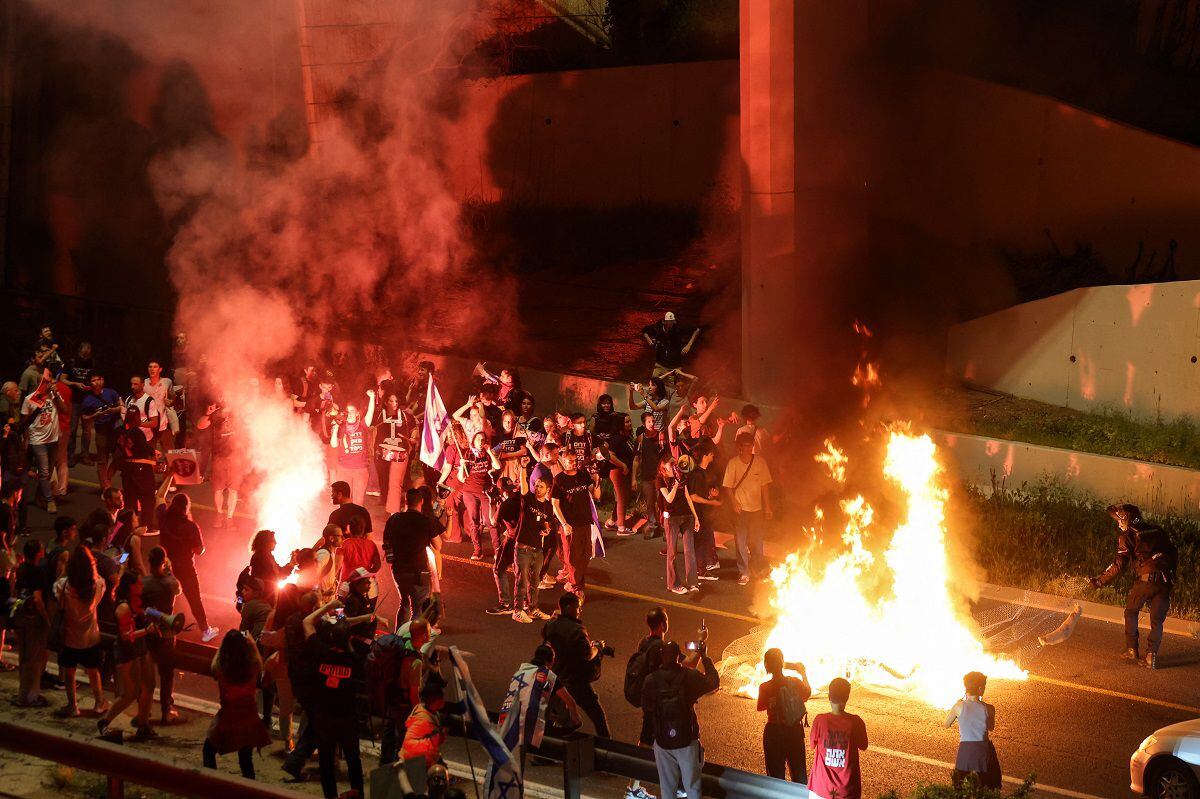Israeli protesters block a main road during a protest against their current government and to demand the release of hostages held by Hamas in the Gaza Strip in Jerusalem on March 31, 2024. (Photo by AHMAD GHARABLI/AFP)