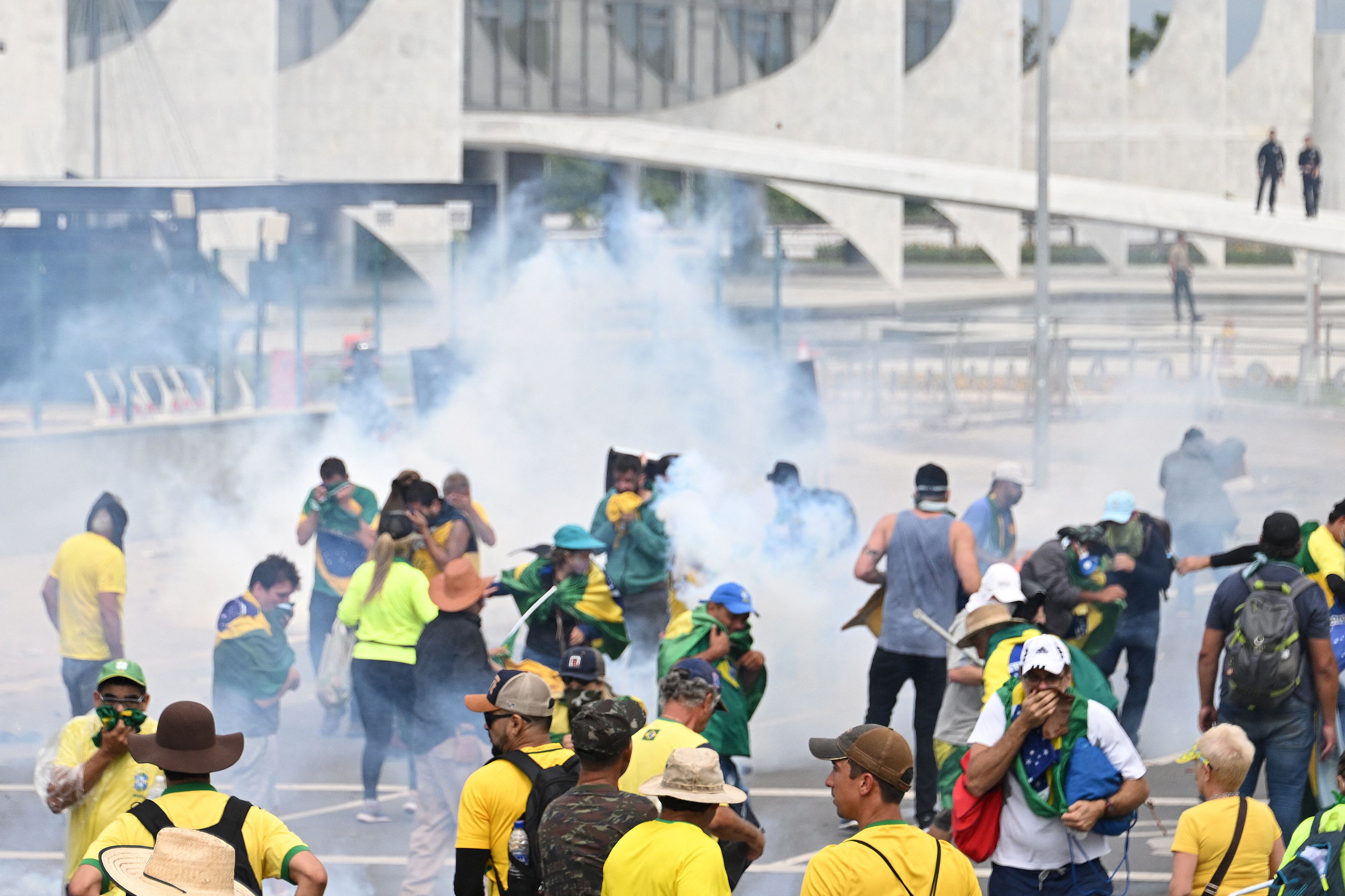 Supporters of former Brazilian President Jair Bolsonaro clash with police during a demonstration in front of the Planalto Palace in Brasilia on January 8, 2023.