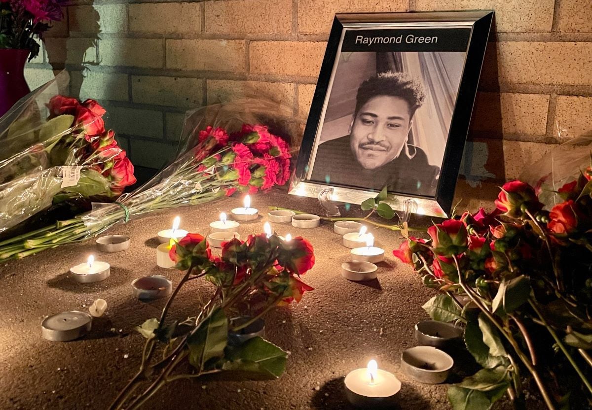 A portrait of Raymond Green Vance surrounded by candles and flowers during a vigil for the victims of the mass shooting at Club Q in Colorado Springs.  (Cecilia SANCHEZ / AFP).