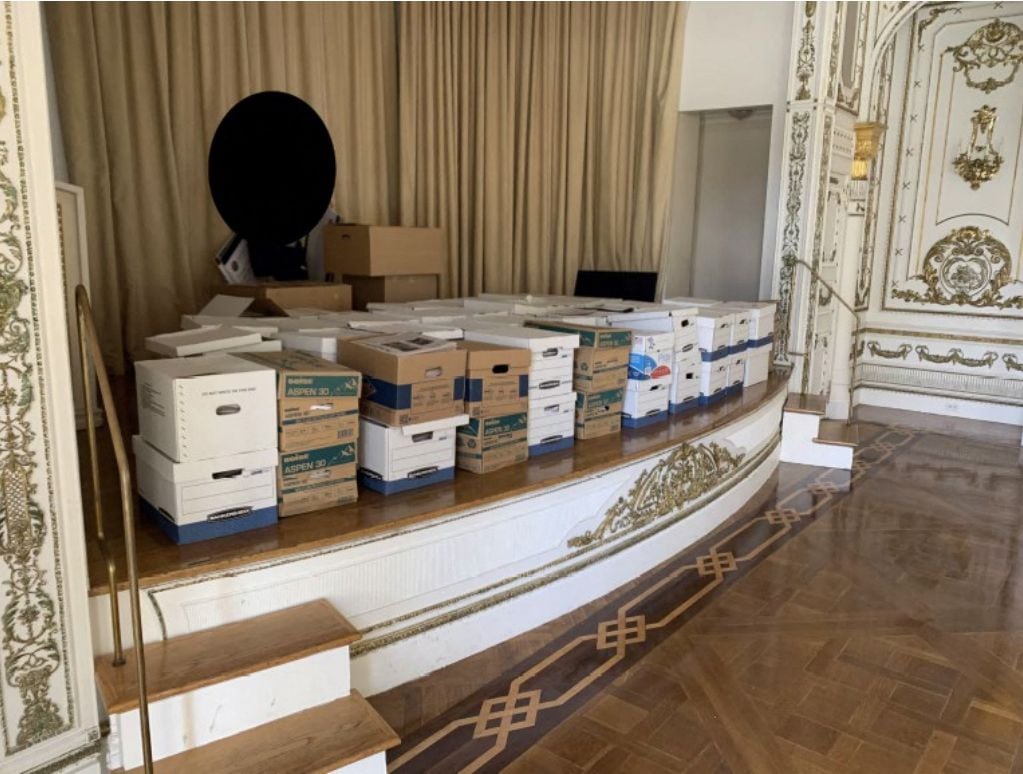 Boxes of documents stored on the stage of the White and Gold Ballroom at Mar-a-Lago, Donald Trump's private club.  (AFP).