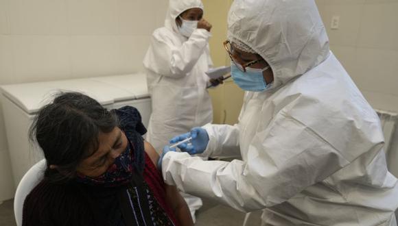 Un trabajador de la salud inocula a una mujer con la vacuna Sputnik V COVID-19 durante una campaña de vacunación para personas mayores de 18 años, en La Paz, Bolivia. (Foto: AP / Juan Karita).