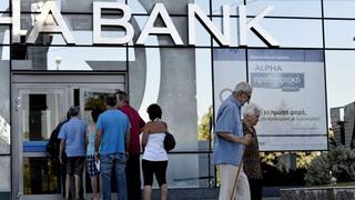 Grecia reabre sus bancos y empieza a pagar a sus acreedores