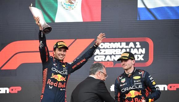 Winner Red Bull Racing's Mexican driver Sergio Perez celebrates with the trophy next to second placed Red Bull Racing's Dutch driver Max Verstappen after the Formula One Azerbaijan Grand Prix at the Baku City Circuit in Baku on April 30, 2023. (Photo by NATALIA KOLESNIKOVA / AFP)